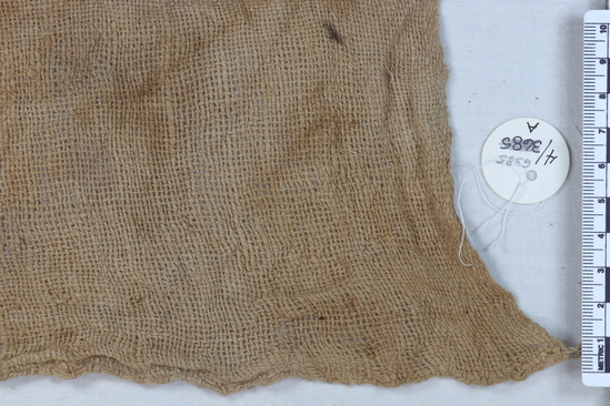 Hearst Museum object titled Cloth, accession number 4-6385a, described as Small brown woolen cloth with white cross design b) and coarse white cotton cloth a)