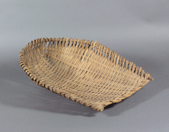 Hearst Museum object titled Winnower, accession number 10-2, described as wicker scoop; u-shape; rice winnower; 19” 1.