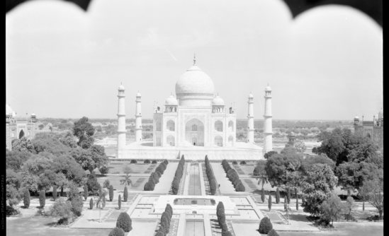 Hearst Museum object titled Black-and-white negative, accession number 15-30352, described as 8 x 10" Black and white negative of the exterior of the Taj Mahal.  Hoefler's original description: "British India. Exterior photograph of the Taj Mahal, shot from a little distance through the curved archway of an adjoining structure. Garden and reflecting pools in the foreground.