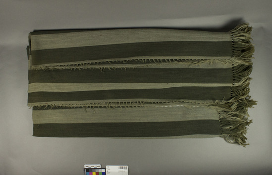 Hearst Museum object titled Shawl, accession number 7-7160, described as Cover or large shawl; wool; warp faced plain weave; knotted fringes; light and dark greenish grey warp stripes; 59.5 inches x 59.5 inches.