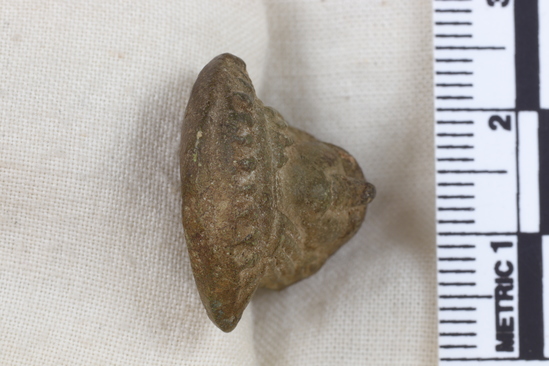 Hearst Museum object 5 of 11 titled Amulet, accession number 5-13917, described as Amulet: anthropomorphic with beadwork collar, long straight hair, bulging eyes, and ears high on head. No holes for stringing amulet. Maybe a fake. Fingerprint on back. Height 2.7 cm.