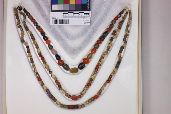 Hearst Museum object 8 of 10 titled Beads, accession number 6-16293, described as Beads: string of shell, carnelian, green stone amethyst, various shapes, l  62 cm. open.