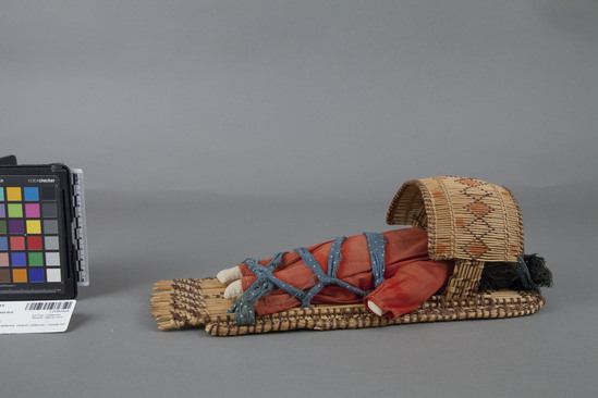 Hearst Museum object 2 of 4 titled Cradle basket and doll, accession number 1-211613a,b, described as (a) Basketry cradle. (b) Rag baby doll.