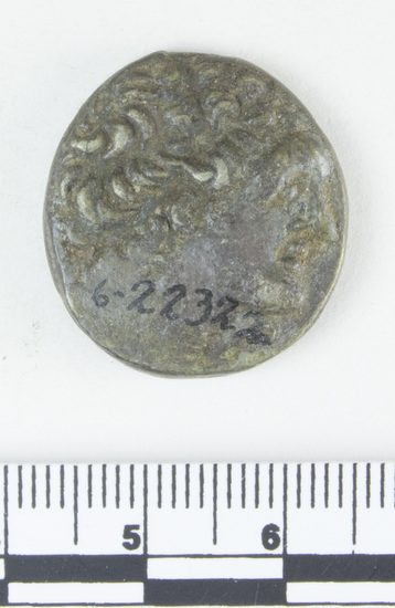 Hearst Museum object 5 of 10 titled Coin: billon tetradrachm, accession number 6-22322, described as Coin, silver base. Diameter 23 mm. Weight 13.37 grams. Condition poor, reverse is very worn. Denomination: silver base tetradrachm. Obverse description: Head of Ptolemy I, facing right, diademed. Reverse description: [inscription] Eagle on thunderbolt, border of dots. Mint date: Alexandria, year 20, reign of Ptolemy XI, Alexander I.