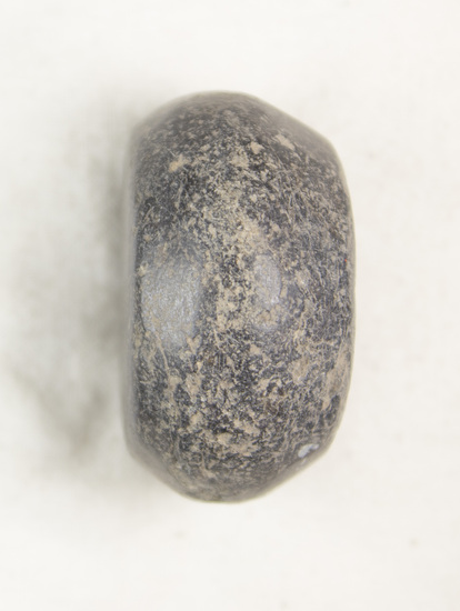 Hearst Museum object titled Scale weight, accession number 6-19469, described as stone: black spherical flattened, used as weight with scale; diameter 3.5 cm