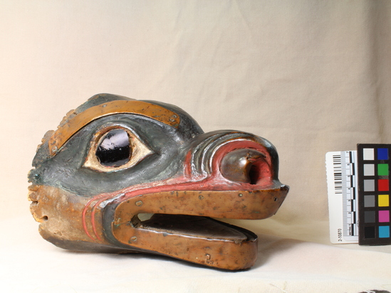 Hearst Museum object 9 of 9 titled Mask, accession number 2-10870, described as Bear head mask, decorated with strips of copper; dark brown glass eyes; wood painted black (?), red and white. Had fur cap attached, now long since destroyed by moths.