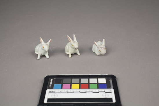 Hearst Museum object 4 of 5 titled Toy rabbits, accession number 9-11043a-f, described as Toys in shape of rabbits (3 large, 3 small);  painted clay;  large, each:  8 cm. l.; 4 cm. w.; small, each:  4 1/2 cm. l.;  3 cm. w.  right ear of 9-11043a is broken off;