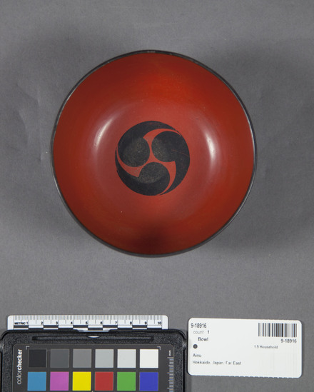 Hearst Museum object 6 of 6 titled Bowl, accession number 9-18916, described as Bowl, wood, lacquered; footed; black lacquer exterior with scroll design in red and yellow; red interior with three-part circular black design at bottom; used to serve individuals.  Used with saucer 9-18917