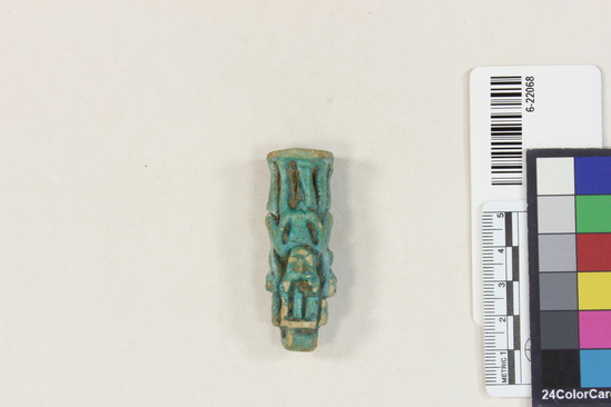 Hearst Museum object 10 of 11 titled Amulet (gods), accession number 6-22068, described as Four-sided amulet of blue faience, showing faience, showing Horus (two sides), Harpocrates, and Serket; length 56 mm.