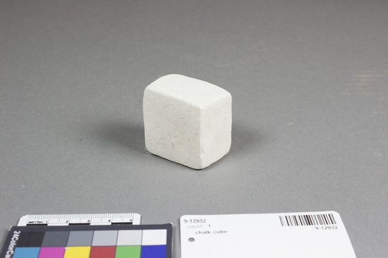 Hearst Museum object titled Chalk cube, accession number 9-12932, described as A white cube of chalk. Native name: "ipoti" or "bapotee". This would have been moistened and rubbed across the forehead during Hindu religious rituals. Cubes of chalk were sold by vendors with incense and other ritual and religious paraphernalia. Width approximately 4.3 cm.