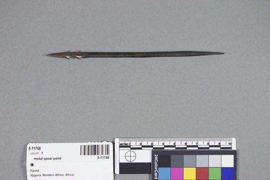 Hearst Museum object titled Metal spear point, accession number 5-11768, described as Kan kibiya- arrowhead, Nigeria, Hausa att. July 27, 1972. 5-11768, acc no. 2879, file code 1.7. Collector: T. Lanagan. Donor: W. H. Lawson. Materials, techniques: round iron shaft, both ends tapered, 4 barbs at one end Context of use: inserted on arrow shaft as weapon Description: projectile point; iron shaft with double barbed head (i.e. 4 barbs); 15.9 cm. l.;