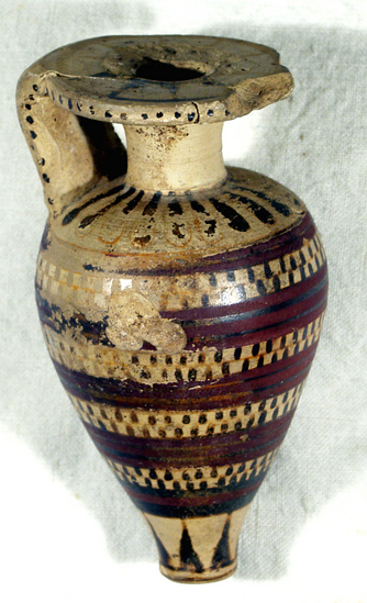 Hearst Museum object titled Aryballos, accession number 8-3446, described as Protocorinthian pointed aryballos; intact save for small chips in mouth and gouge in body; glaze worn; added purple paint; around mouth, 10 rays; dots on rim and sides of handle across back of handle, 5 (?) bars; tongues on shoulder; body, 5 bands of glaze; between the bands, dicing; at base rays Height7.2; Diameter 3.8 cm