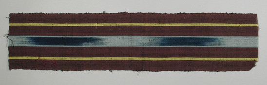 Hearst Museum object 2 of 2 titled Textile fragment, accession number 5-11336, described as textile sample (section of narrow band weaving): outside panels maroon with central yellow stripe, central ikat: blue and light blue flanked by light blue.