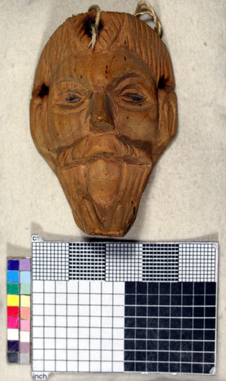 Hearst Museum object titled Toy mask, accession number 3-15595, described as Carved wooden toy mask; unpainted and signed "Miguel Dynans