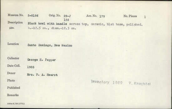 Documentation associated with Hearst Museum object titled Bowl, accession number 2-8186, described as Black bowl, with handle across top, ceramic. Flat base, polished. Height 12.5 cm., diameter 12.3 cm.