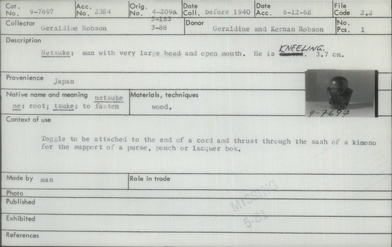 Documentation associated with Hearst Museum object titled Netsuke, accession number 9-7697, described as Netsuke: man with very large head and open mouth. He is seated. ["seated" crossed out and "kneeling" handwritten on catalog card.]