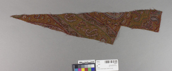 Hearst Museum object 1 of 6 titled Shawl, accession number 7-6640a-f, described as Five remnants fo Paisley shawl.  Wool.  Twill weave, brocaded.  Varicolored.  Floral, pine cone motives.  Condit. good.  A.  29 inches by 30 inches, very irregular.  B.  16¼ inches by 29½ inches, irregular.  C.  3¼ inches by 21 inches, irregular.