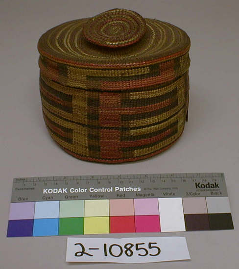 Hearst Museum object titled Basket and lid, accession number 2-10855, described as Twined, with oblong design in red and yellow bands of blue on inside cover with design, rattle on knob of cover.