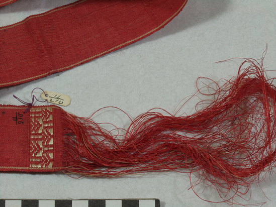 Hearst Museum object 3 of 3 titled Belt, accession number 11-210, described as Belt or ribbon of fiber, red.