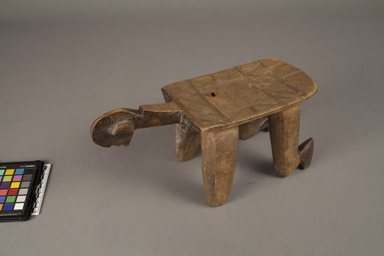 Hearst Museum object 2 of 3 titled Stool (seating furniture), accession number 5-11705, described as Stool; carved, anthropomorphic (kneeling figure), linear design incised on seat, light brown in color.