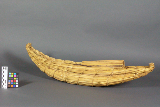 Hearst Museum object titled Model boat, accession number 16-7944, described as Model totora balsa with sail and wooden mast raised at top length 29 inches, model of reed boat, Lake Iticaca, Peru & Bolivia.