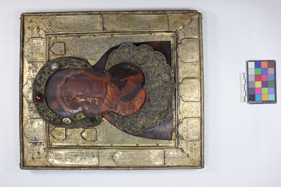 Hearst Museum object 15 of 49 titled Icon, accession number 7-3541, described as Icon of “Our lady of Vladmir”; Virgin and Child in tempera and gesso on wood; gilded silver basma; cloisonne halo with cloisonne collar pendant; halo has glass and amber (?) ornamentation; Virgin’s face damaged; height 30.2 cm, width 26 cm.