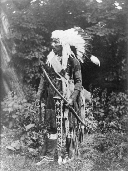 Hearst Museum object titled Photograph, accession number 13-95, described as Omaha man wearing traditional clothes and headdress.