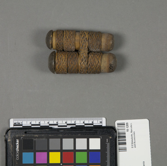 Hearst Museum object titled Container; lid, accession number 10-1209, described as Container for lime and gambia betel chewing; double; bamboo; tied with bands of plaited rattan; round button lids; 1 has grass in it; 3x1 3/4”.