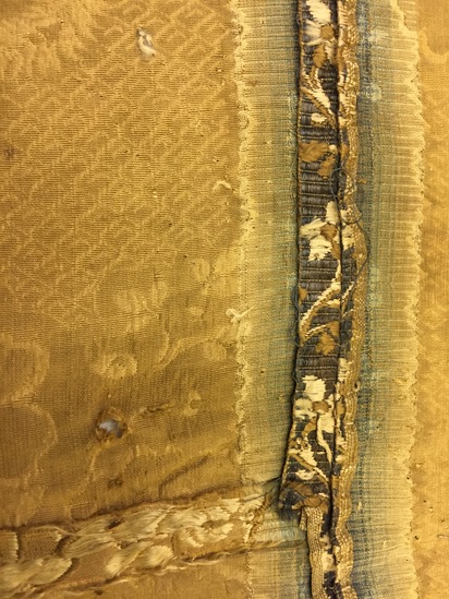 Hearst Museum object 43 of 49 titled Icon, accession number 7-3541, described as Icon of “Our lady of Vladmir”; Virgin and Child in tempera and gesso on wood; gilded silver basma; cloisonne halo with cloisonne collar pendant; halo has glass and amber (?) ornamentation; Virgin’s face damaged; height 30.2 cm, width 26 cm.