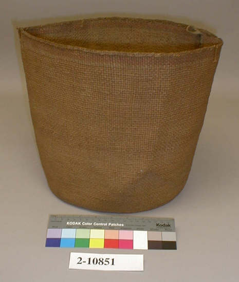 Hearst Museum object titled Basket, accession number 2-10851, described as Closely twined, brown with band of red and green design at top. 2 cotton loops for suspension.