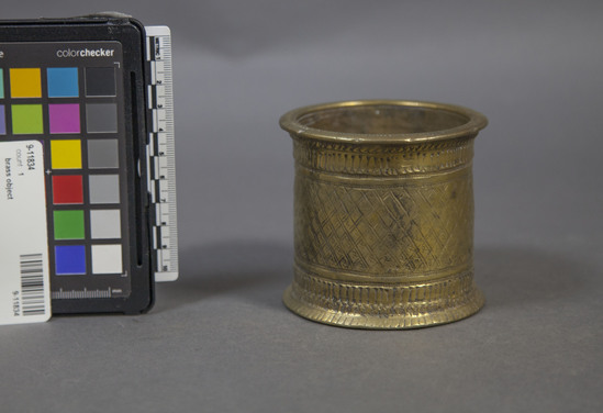 Hearst Museum object titled Vessel, accession number 9-11834, described as Vessel; ritual water vessel; cylindrical brass vessel with incised crosshatching in center; flanged lip.