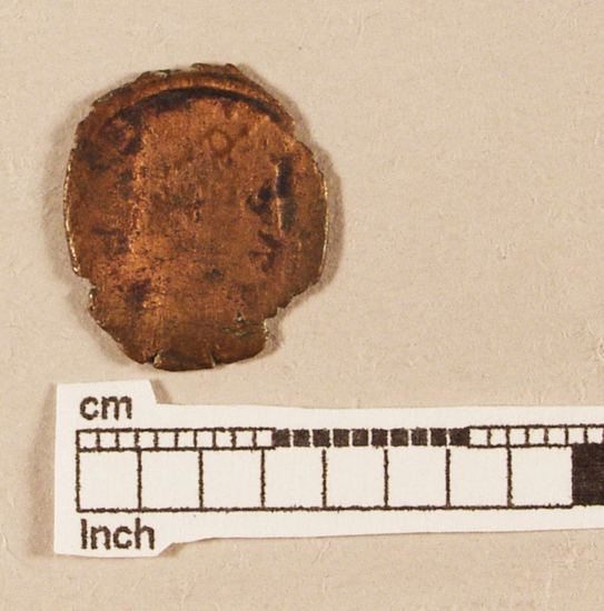 Hearst Museum object titled Coin: æ 4, accession number 8-7346, described as Coin, AES Follis 4.       0.95 grams. 15mm. Obverse: Constantius II Reverse: wreath enclosing  VOTXX   MVLXXX