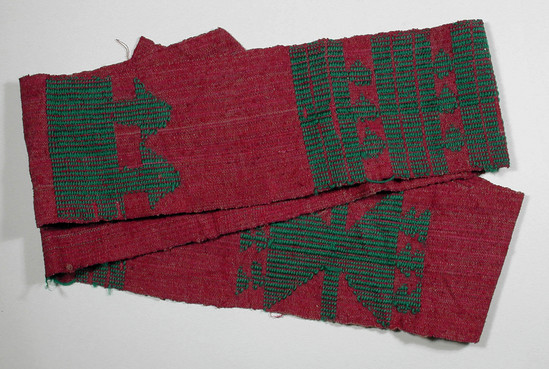 Hearst Museum object titled Textile fragment, accession number 5-11352, described as textile sample (section of narrow band weaving): green brocade on solid red textured background in five patterns (a) weft stripes (b) dolls, (c) (d) (e) unidentified.