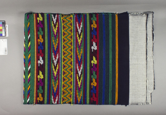 Hearst Museum object titled Textile, accession number 3-30219, described as RGM yardage, 17 1/4" by 4 feet long, matched pair basted together in several spots, ends are unfinished and grey in color (a mix of black and white threads), bands run the width and are woven of brilliant colors, designs reverse directions in the middle green band (like a table runner), four bands of multicolored birds are on each piece.