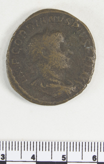 Hearst Museum object 2 of 7 titled Coin: æ sestertius, accession number 8-6493, described as Coin. Æ. Roman (19.0 grams; 32 mm.) Gordian III Ru. Ceves, AD.   Rome. Obverse: IMP GORDIANVS PIVS FEL AVG - Bust facing right, laureate and draped. Reverse: P M T R P IIII COS  III P P - Apollo seated facing left, holding branch and resting left arm on lyre; in exergue, S C.