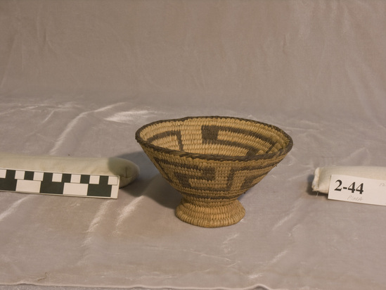 Hearst Museum object titled Basket, accession number 2-44, described as Coiled, with flaring sides, pedestal base. Fret design in black on body.  Black material is Martynia probosidea and light material is willow or cottonwood.