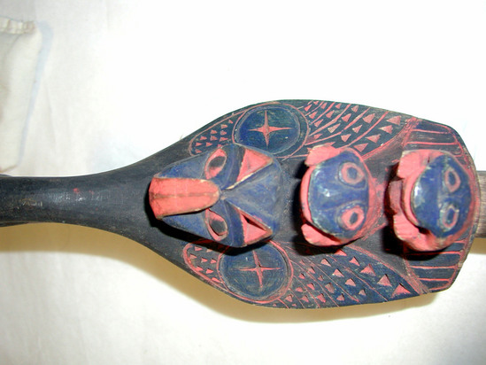 Hearst Museum object 1 of 4 titled Rattle, accession number 2-4618, described as Bird shaped (loon with otter and 2 frogs on back); carving of sparrow hawk on underside; painted red, blue and black.