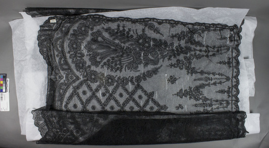 Hearst Museum object 1 of 3 titled Shawl, accession number 3-11063, described as Black lace shawl, floral patterned.