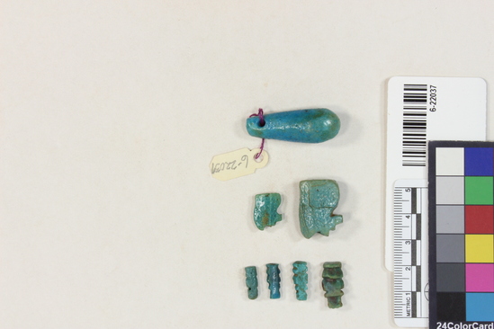 Hearst Museum object 22 of 22 titled Amulets, accession number 6-22037, described as amulets, of blue faience, and one pyramidal seal of steatite