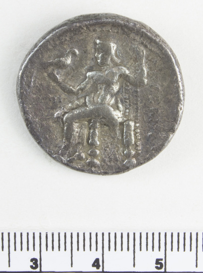 Hearst Museum object 3 of 6 titled Coin: ar tetradrachm, accession number 8-4743, described as Coin; AR; Tetradrachm; Greek. 16.33 grams, 28 mm. Alexander the Great, 336-323 BC. Obverse: Head of Heracles r. Reverse: ΑΛΕΞΑΝΔΡΟΥ, Zeus seated l., eagle on outstretched r. hand, scepter in l.