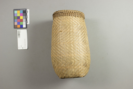 Hearst Museum object titled Basket, accession number 5-1752, described as Women's fishing basket (nkūn); light cylindrical shape, 4.5" 11.43cm rim diameter, 8" 20.32cm height Woven by women exclusively