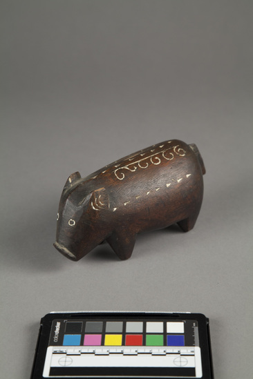 Hearst Museum object 2 of 3 titled Carving of pig, wood, incised, accession number 11-42725, described as Carving of pig, wood, incised; black with white incisions. length - 17.0 cm., height - 8.0 cm.