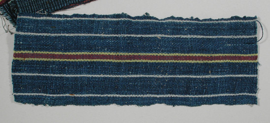 Hearst Museum object titled Textile fragment, accession number 5-11123, described as Textile sample (section of narrow band weaving): cotton; four narrow white stripes (two each side of central stripe); central stripe deep red flanked by yellow stripes.