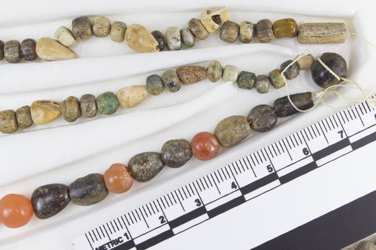 Hearst Museum object 7 of 10 titled Beads, accession number 6-16293, described as Beads: string of shell, carnelian, green stone amethyst, various shapes, l  62 cm. open.