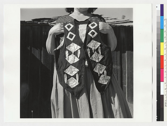 Hearst Museum object titled Black-and-white negative, accession number 15-20244, described as Essie Parrish holding costume; black vest decorated with white diamond shapes