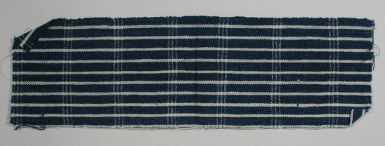 Hearst Museum object 2 of 2 titled Textile fragment, accession number 5-11084, described as Textile sample (section of narrow band weaving): Royal blue ground with ten narrow white stripes; series of double white lines on weft; loops on left white selvage.