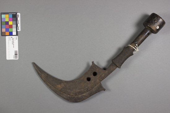 Hearst Museum object titled Throwing knife, accession number 5-15193, described as Knife; curved iron blade, wooden handle with wrapping of fiber. Iron tacks. Blade rusty, edged on both sides. Length: 39 cm. Throwing knife, curved, sharp on both ends.