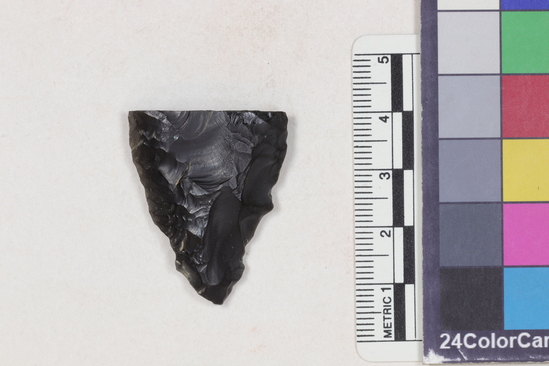 Hearst Museum object 1 of 2 titled Projectile point fragment, accession number 16-14312, described as Projectile point; obsidian; triangular; weight: 7.44 grams; length: 3.4 cm; width: 2.8 cm; depth: 0.8 cm; convex sides; broken.