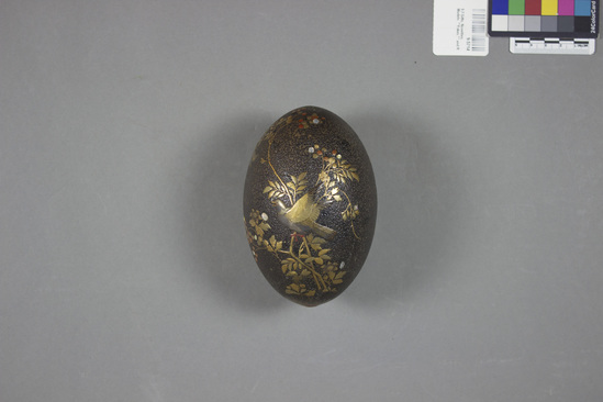 Hearst Museum object titled Egg, accession number 9-5714, described as Egg, lacquered; birds and foliage in gold lacquer with mother-of-pearl inlay; broken and repaired; rough brown lacquer ground; height ca. 13.2 cm, diameter ca. 9 cm.