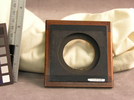 Hearst Museum object titled Aperture board, accession number 2-72038, described as Aperture board for Field View Camera.  9.2cm x 9.3cm.  Aperture opening 4.3cm.